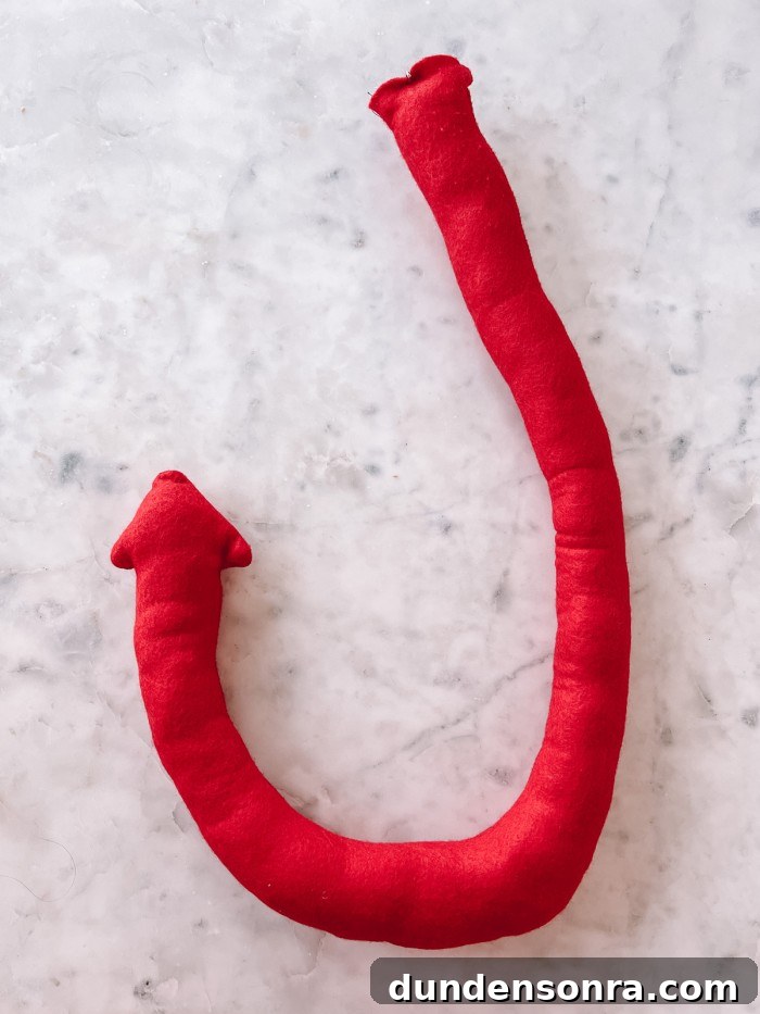 red felt devil tail on marble table