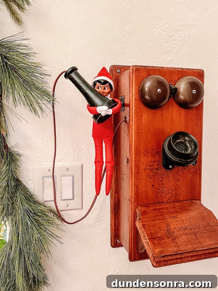 Elf on the Shelf hanging on old phone
