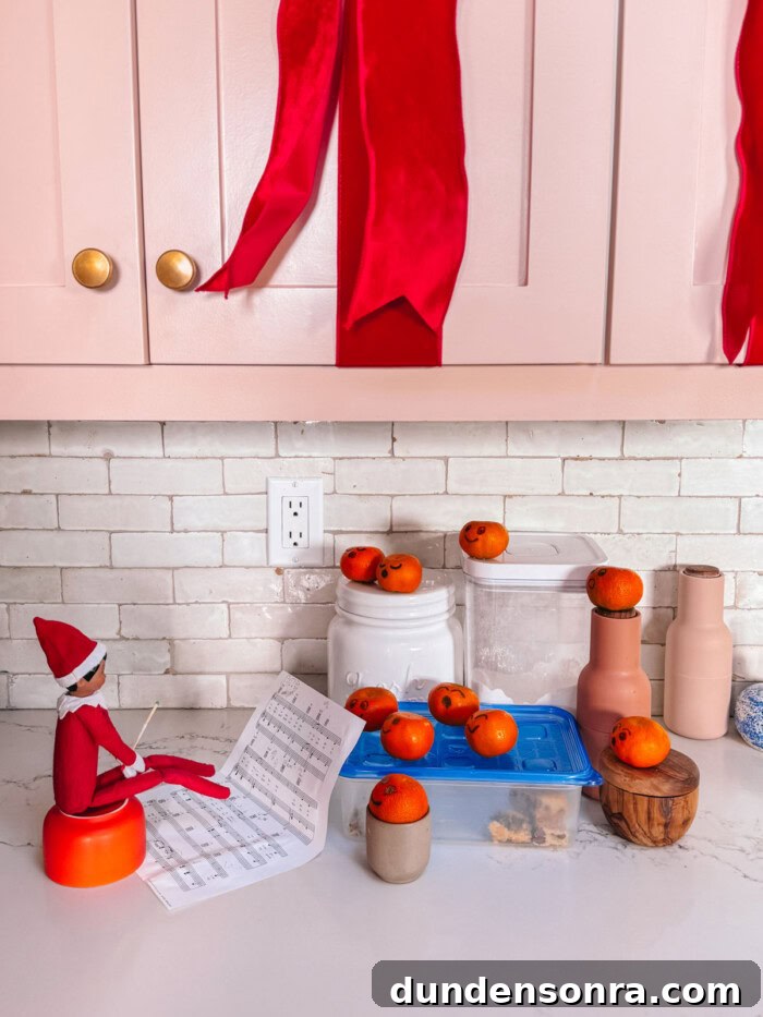Elf on the Shelf conducting a choir of clementines