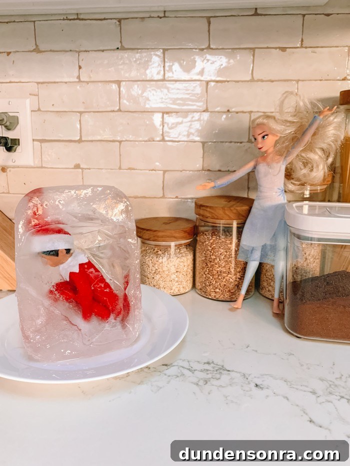 Elf on the Shelf frozen in ice with Elsa doll