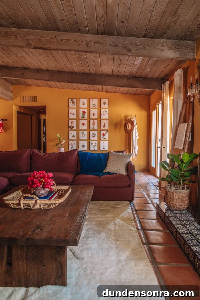 gallery wall behind purple couch in ochre living room