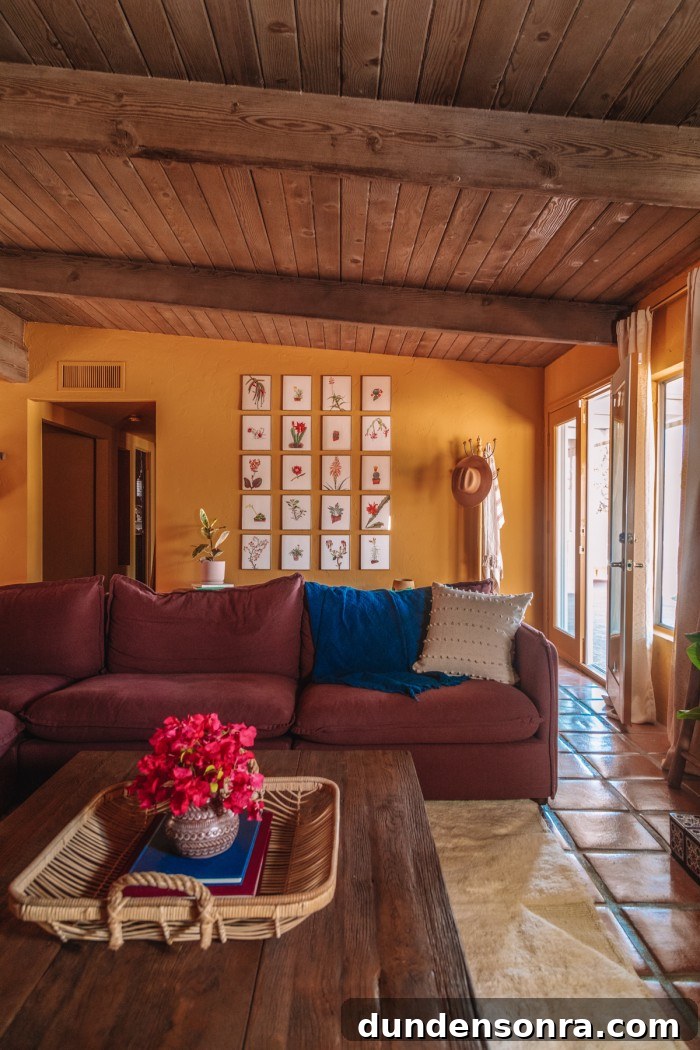 plum couch with gallery wall behind it