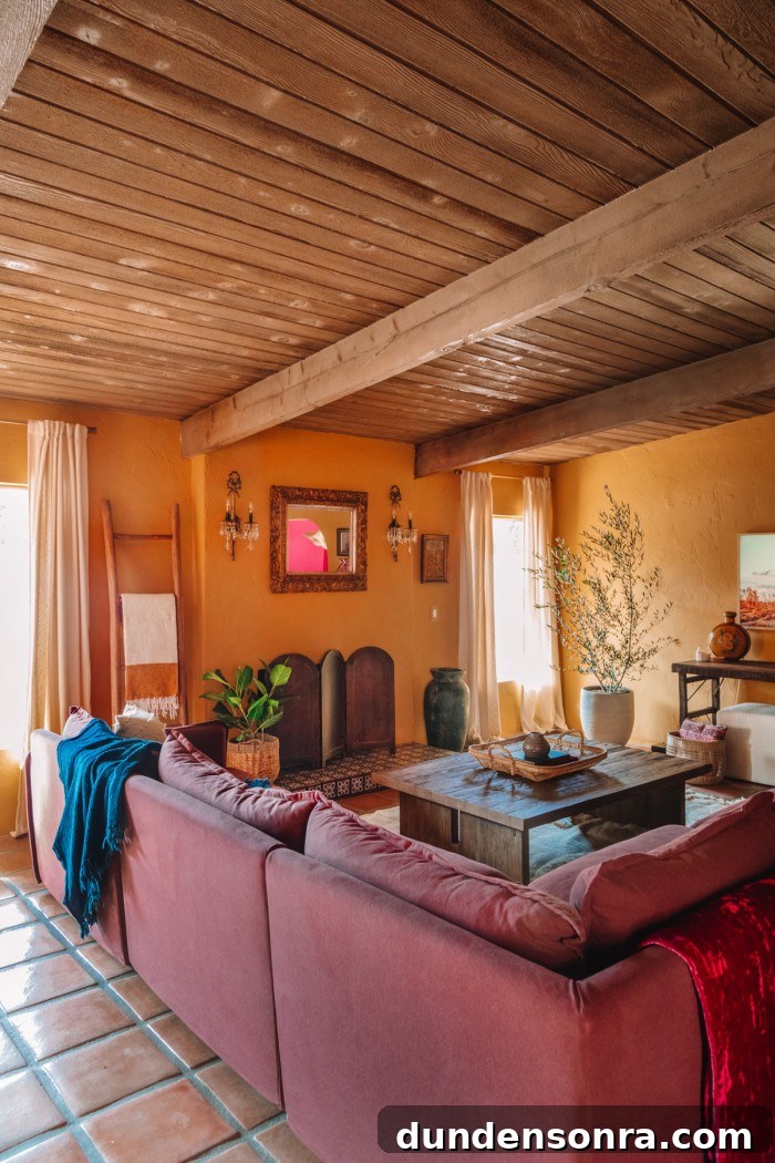 plum couch in living room with ochre walls