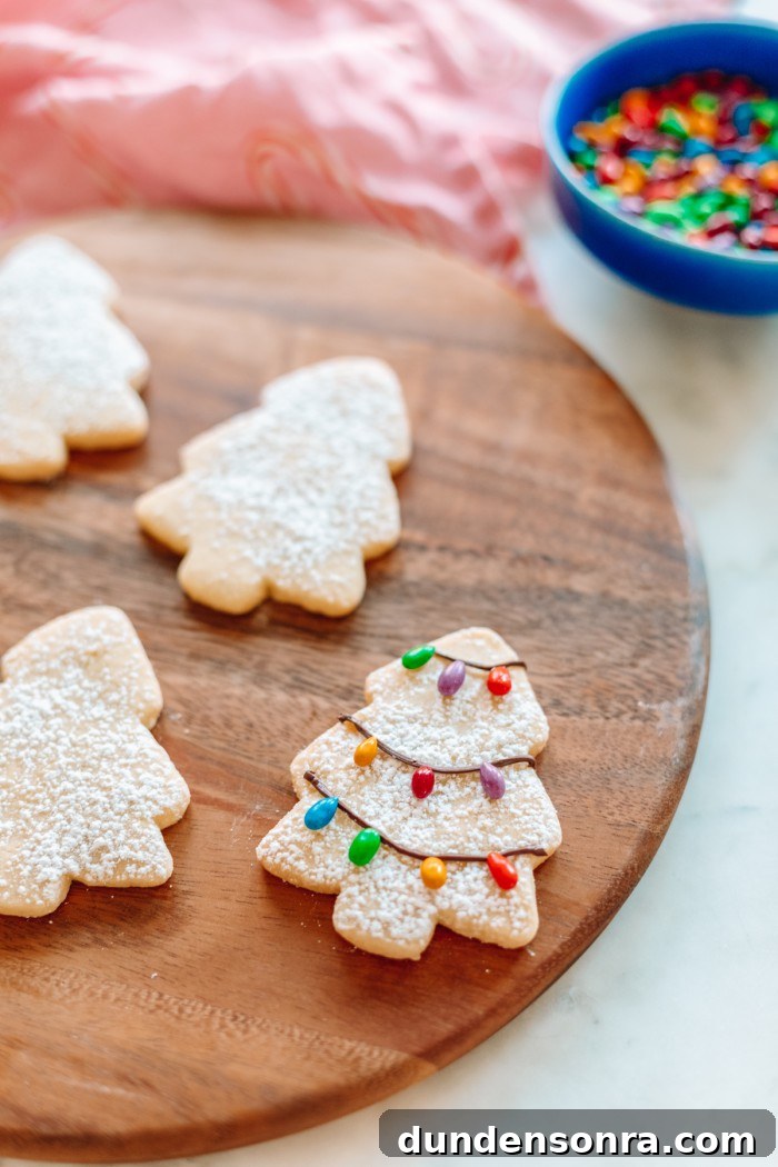 Tree cookie with chocolate Christmas lights on wood board