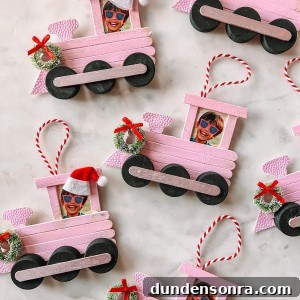 Popsicle stick train Christmas ornaments on marble table