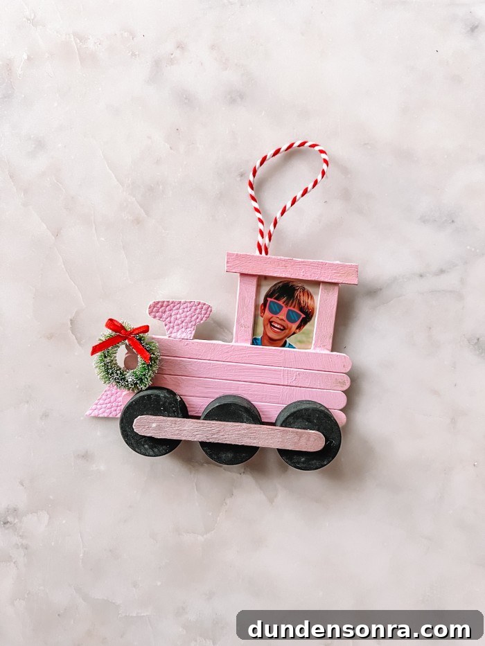 Popsicle Stick Train Christmas Ornament on marble table