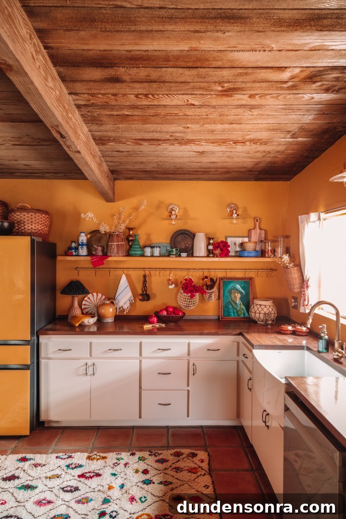 yellow kitchen with cream cabinets and wood ceilings