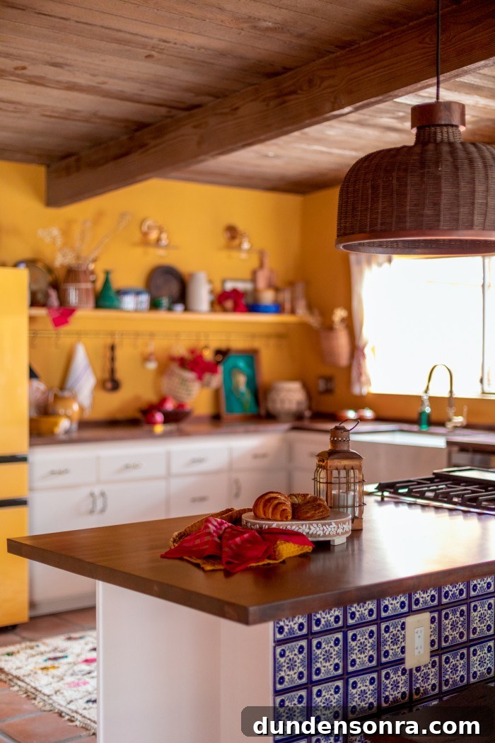 yellow kitchen with dark butcher block counters and wood ceilings