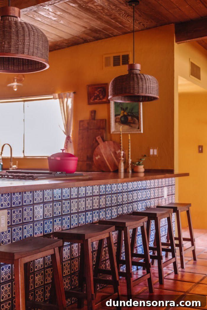 yellow kitchen with blue and white tiled peninsula and butcher block counters 