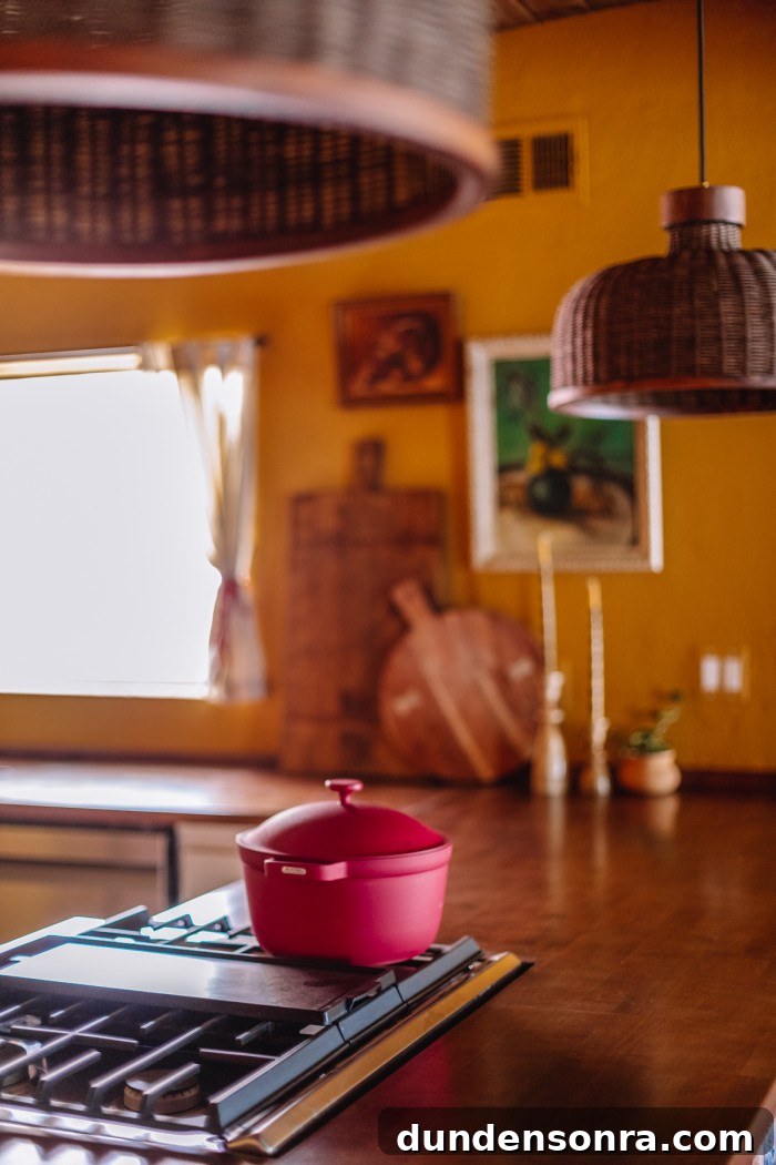 pink pot on stove in yellow kitchen