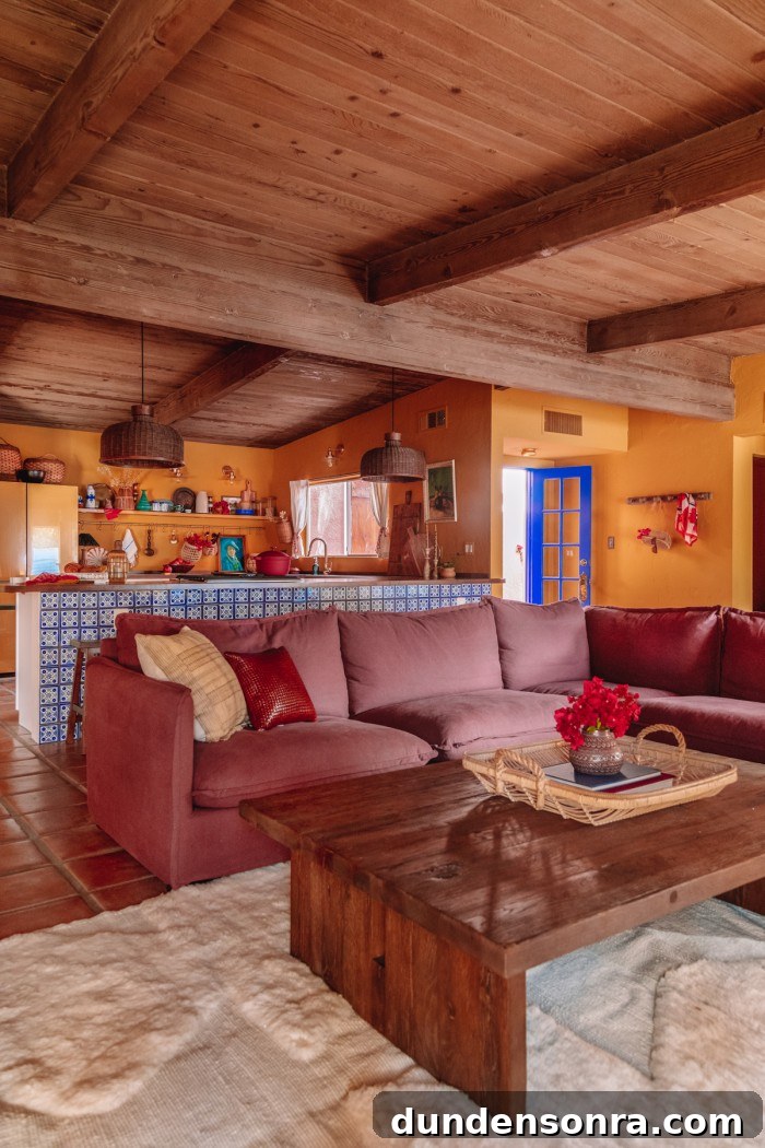 Purple couch in yellow room with kitchen behind it