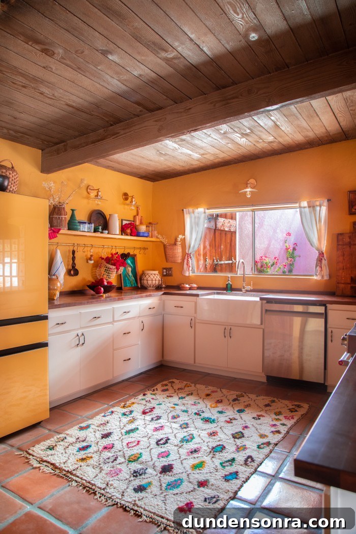 yellow kitchen with multicolor rug on terracotta floor