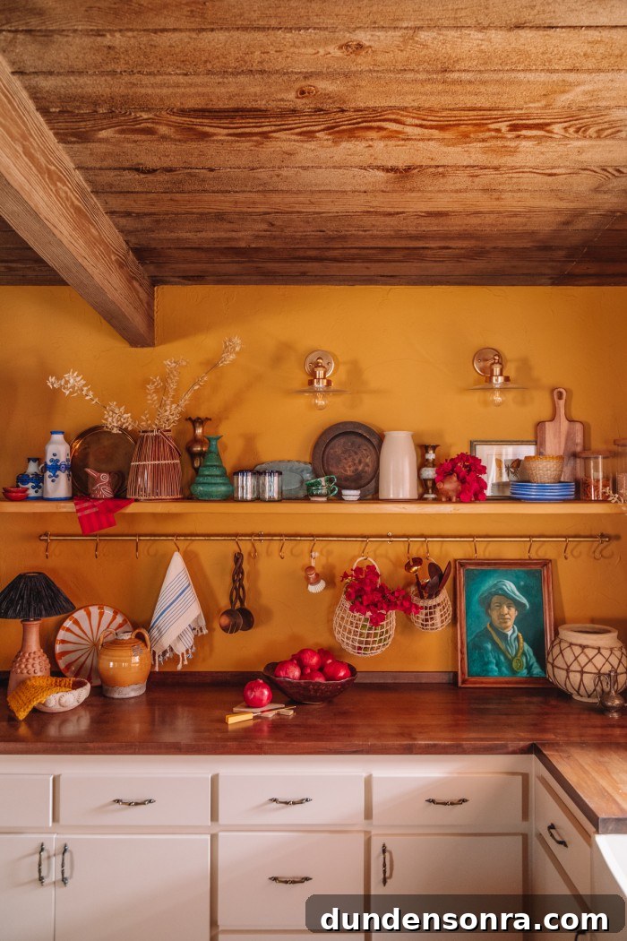 ochre yellow kitchen walls with shelf and brass pot rail