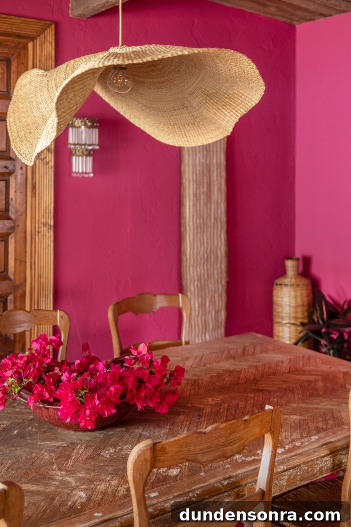 Magenta Pink Dining Room Ideas: Bold Color Decor Inspiration 13 table with bougainvillea on it and rattan chandelier in pink room
