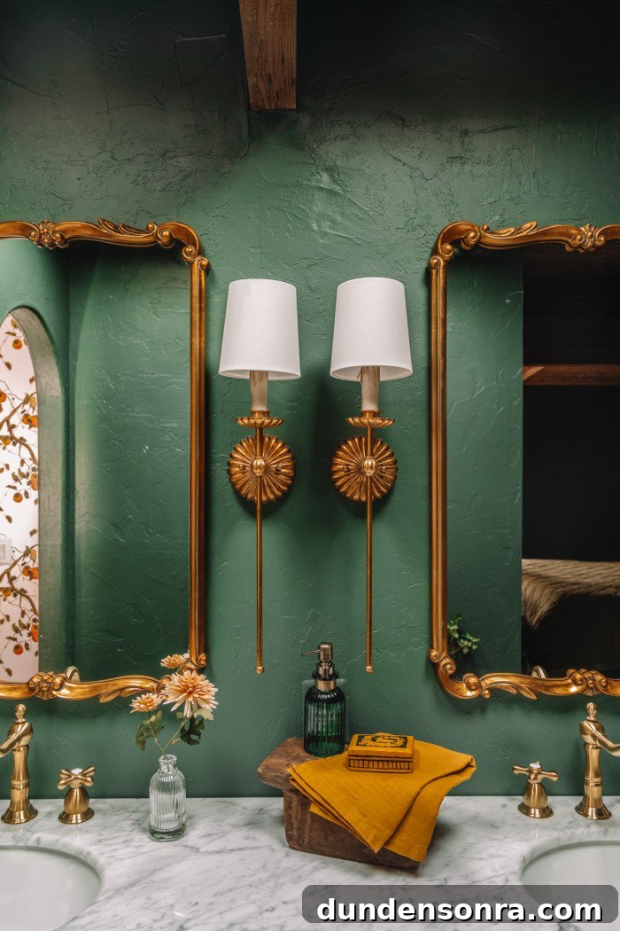 brass sconces in green bathroom