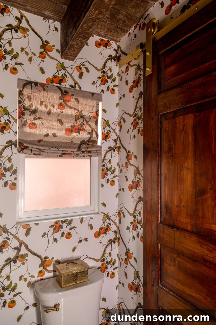 antique door as barn door in floral bathroom