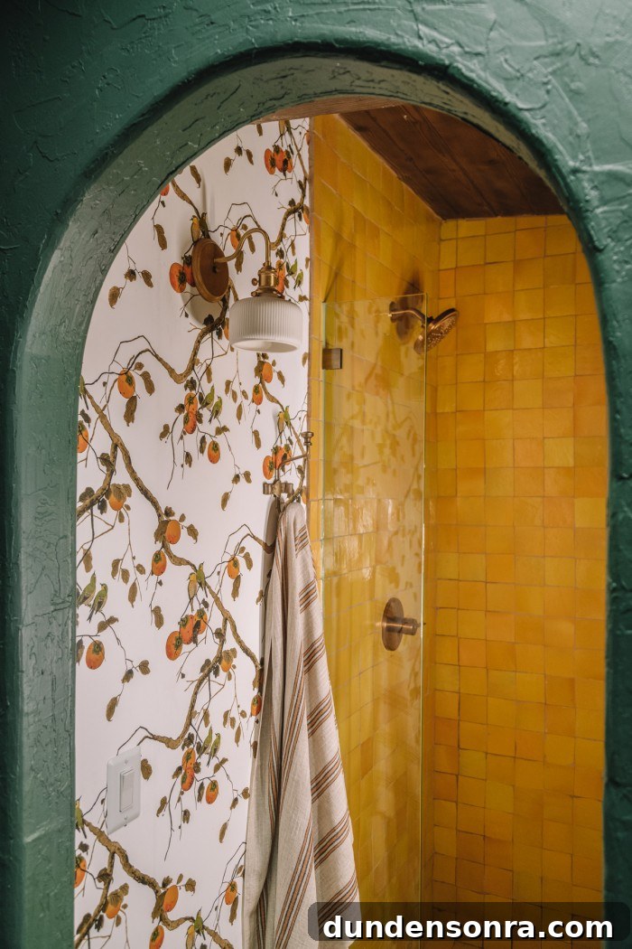 dark green arch with floral wallpaper and yellow tile shower