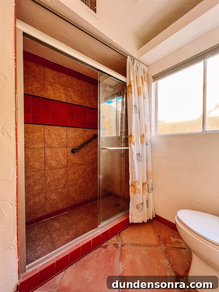 Rich, Moody Purple Bathroom Design Ideas 6 bathroom shower with orange stripe of tile