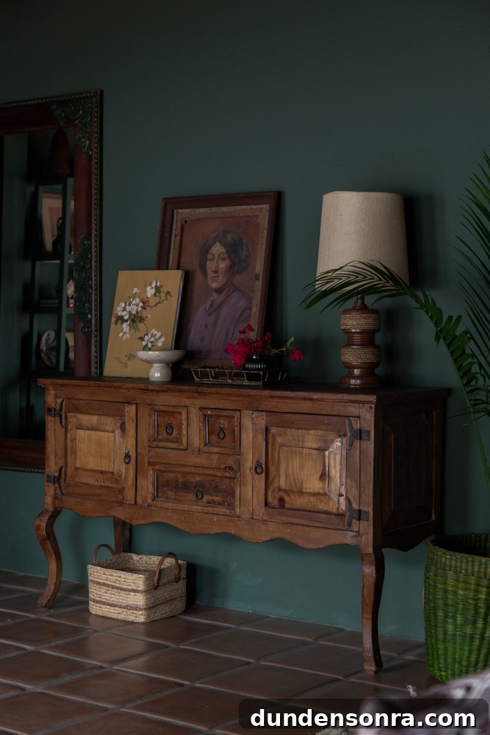 Monochromatic Dark Green Bedroom Ideas and Decor Tips 18 credenza in bedroom with vintage art and lamp on top