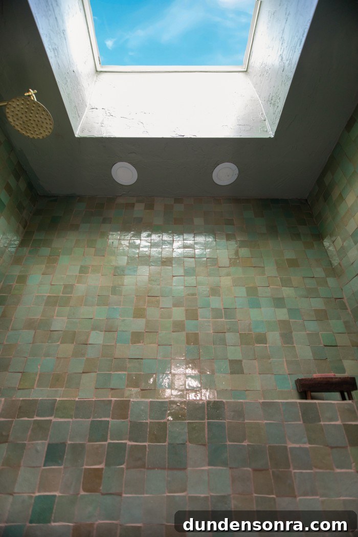 skylight in sage green tiled shower
