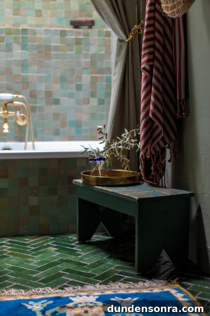 green bathroom with blue rug and stool