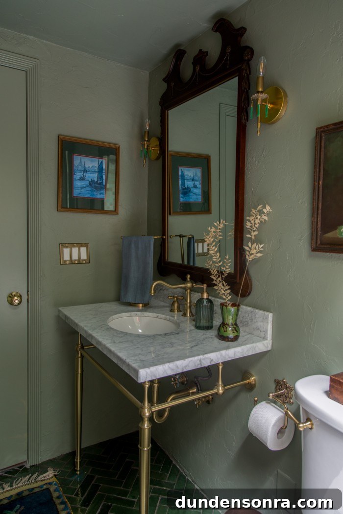 sage green bathroom with wood mirror and marble vanity