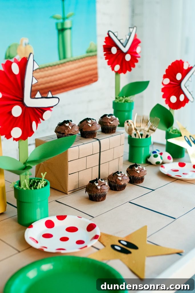 24 Super Mario Birthday Party Ideas to Wow Fans of All Ages 4 Mario themed tablescape with homemade cupcakes.