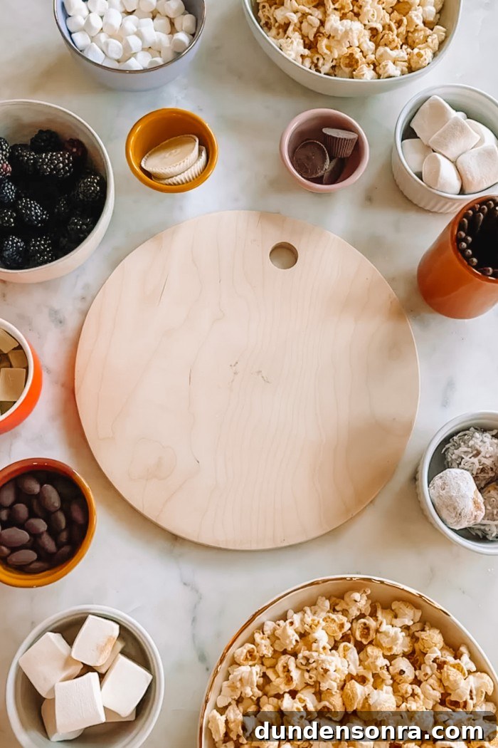 Jack Skellington Dessert Charcuterie Board Ideas for Parties 3 round cutting board on table surrounded by candy