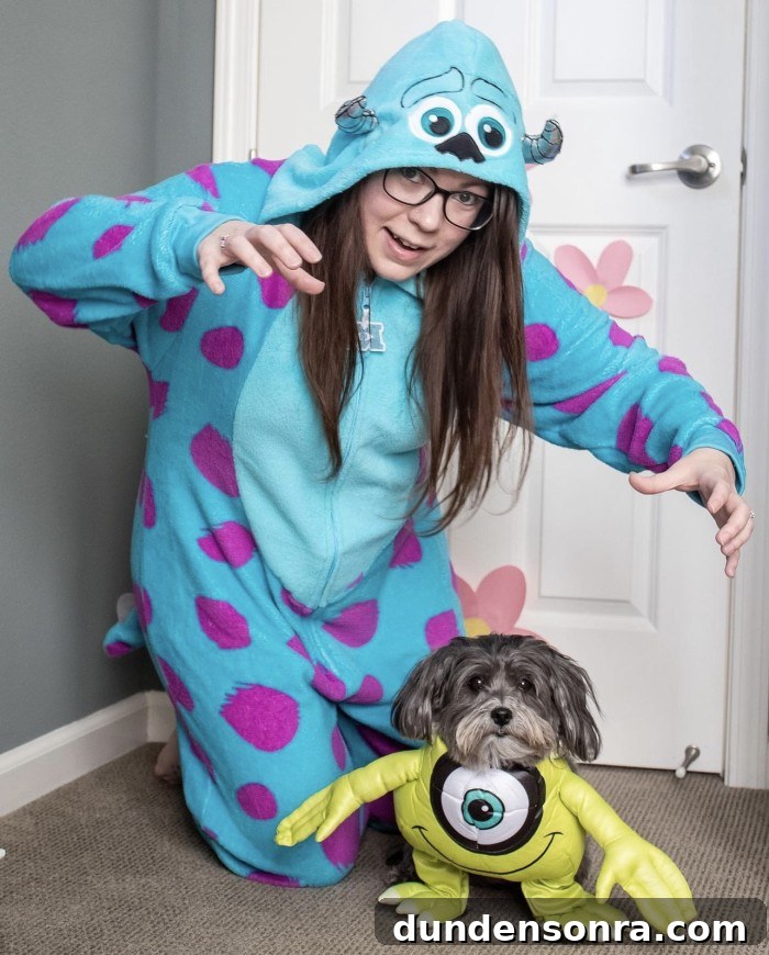 dog dressed up as Mike Wazowski and person dressed up as Sully from Monster's Inc