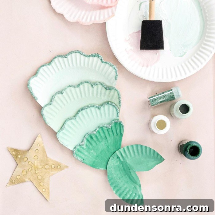 Mermaid Crafts for Kids: 25 Fun Underwater DIY Ideas 12 Paper plate mermaid craft on a table.