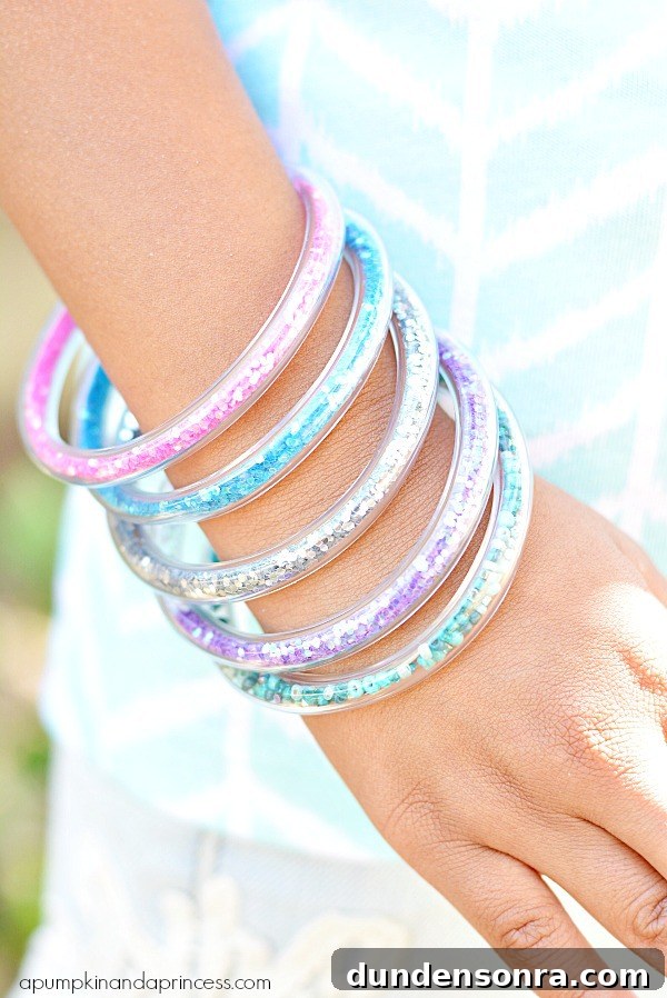 Mermaid Crafts for Kids: 25 Fun Underwater DIY Ideas 8 Glitter bracelets on child's arm.