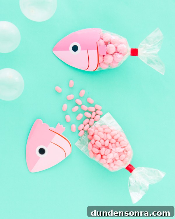 Fish party favor bag on a table filled with candy.