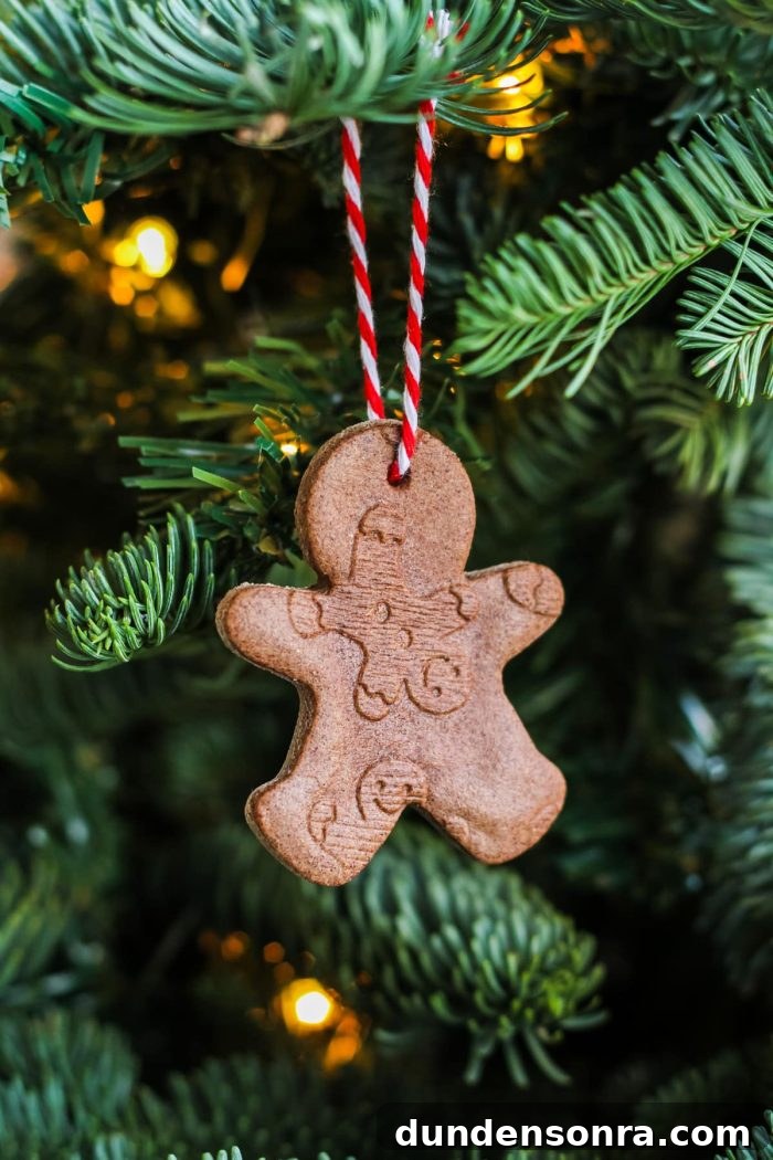 Handmade Christmas Ornaments Kids Can Make at Home 18 Gingerbread man ornament hanging on a tree.