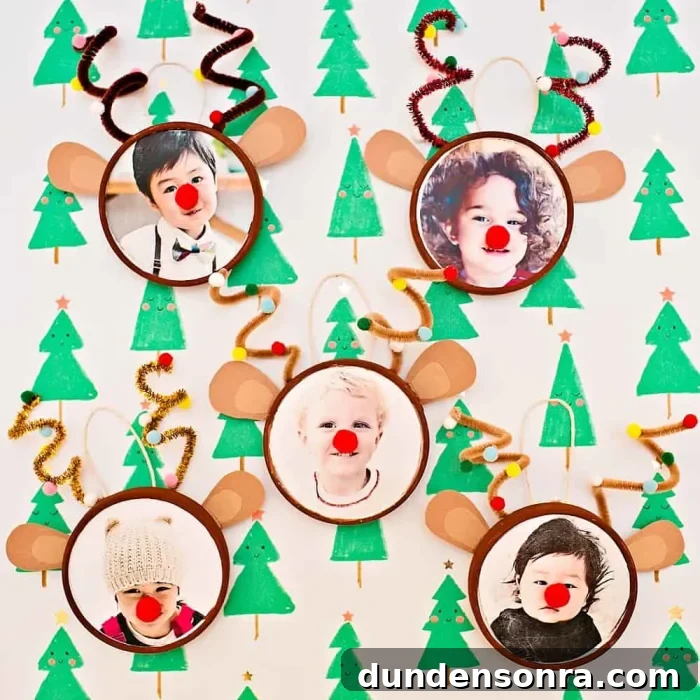 Handmade Christmas Ornaments Kids Can Make at Home 19 Reindeer ornaments with photos on a background with green trees on it.