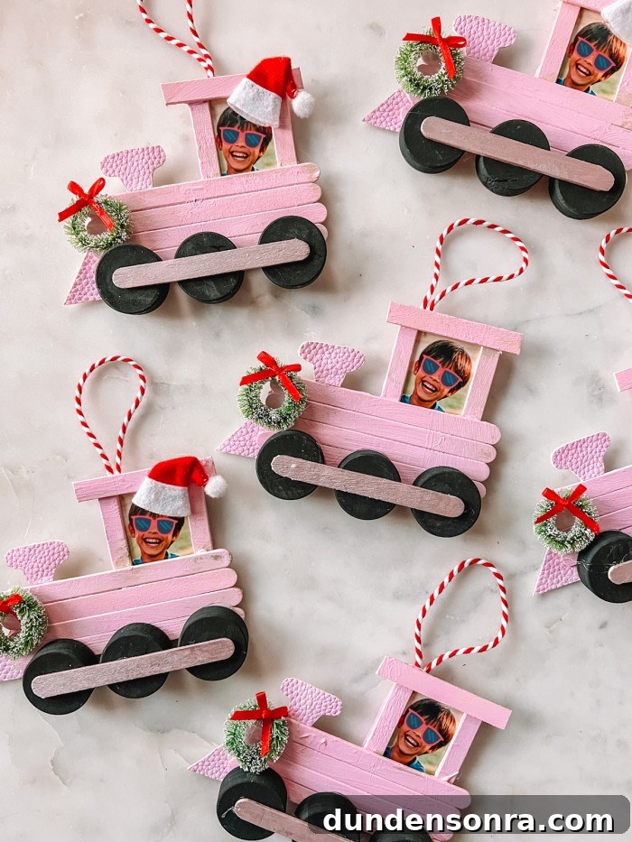 Handmade Christmas Ornaments Kids Can Make at Home 3 Popsicle stick train Christmas ornaments on marble table
