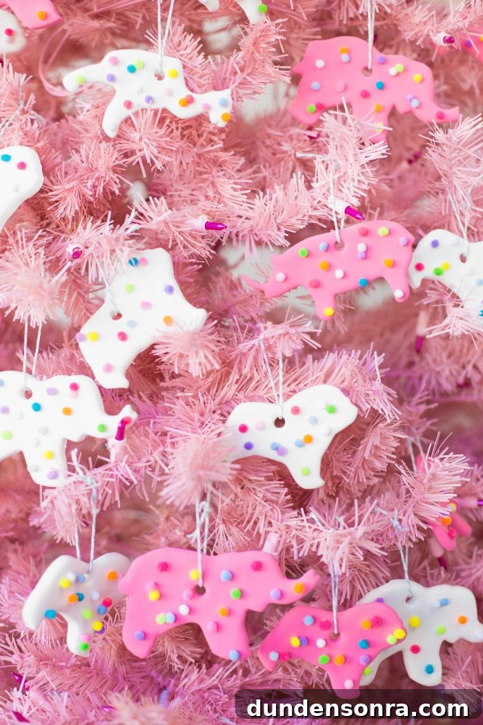 Handmade Christmas Ornaments Kids Can Make at Home 5 DIY Circus Animal Cookie Ornaments hanging on a pink tree.