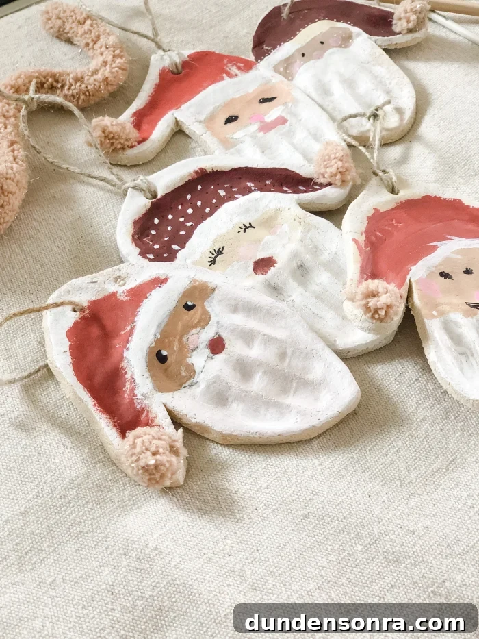 Handmade Christmas Ornaments Kids Can Make at Home 10 Christmas ornaments in the shape of santa's head on a tan cloth.