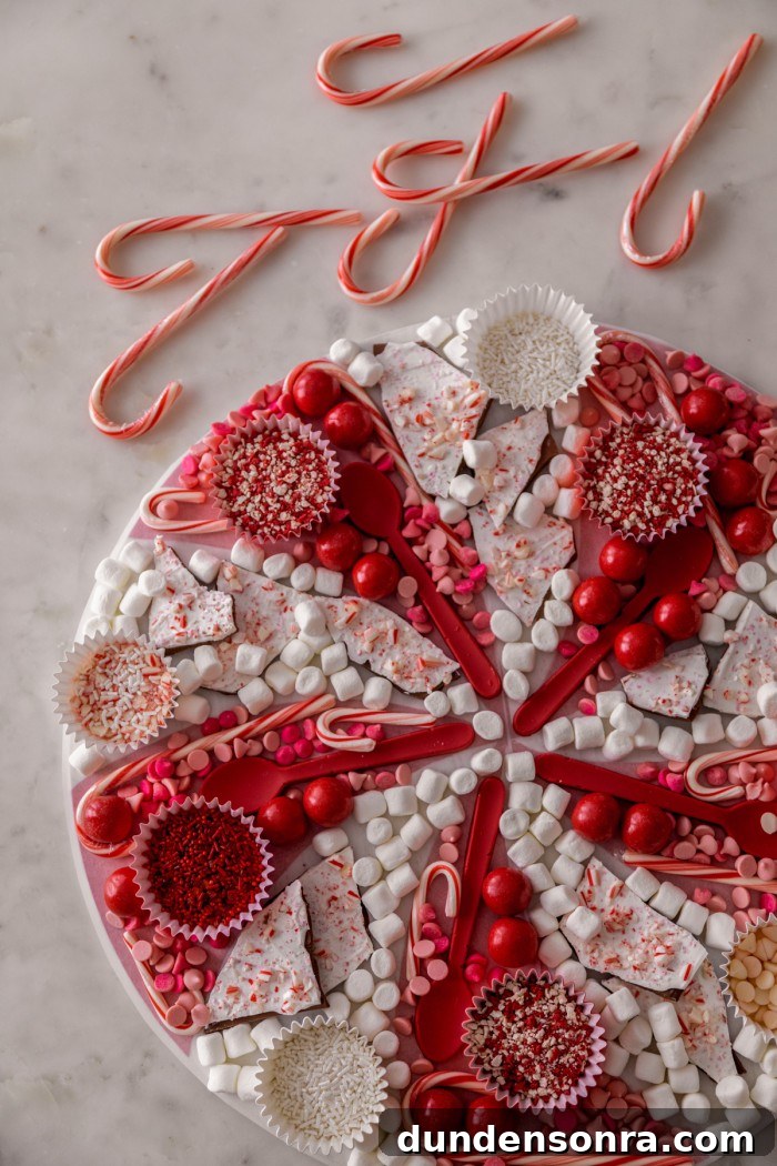 Christmas Hot Chocolate Board Overhead shot of a hot chocolate board with red and white hot chocolate toppings.