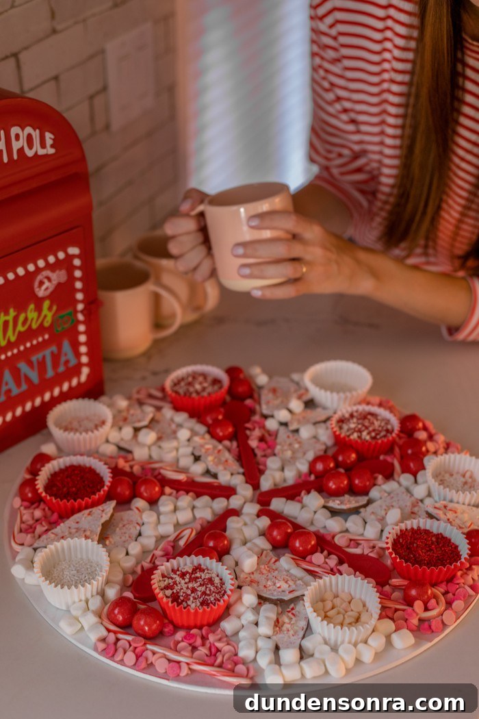 Easy Hot Chocolate Board Christmas hot chocolate board with woman in background holding a pink mug.