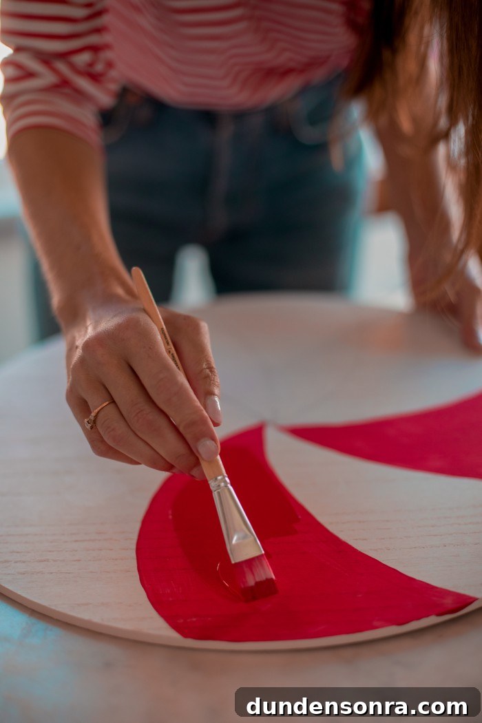 Homemade Hot Chocolate Board Hand paining a white board with red swirls to make it look like a peppermint.