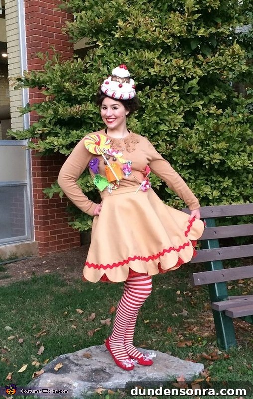 Gingerbread Christmas Costume Woman standing outside dressed as a gingerbread girl with striped stockings.