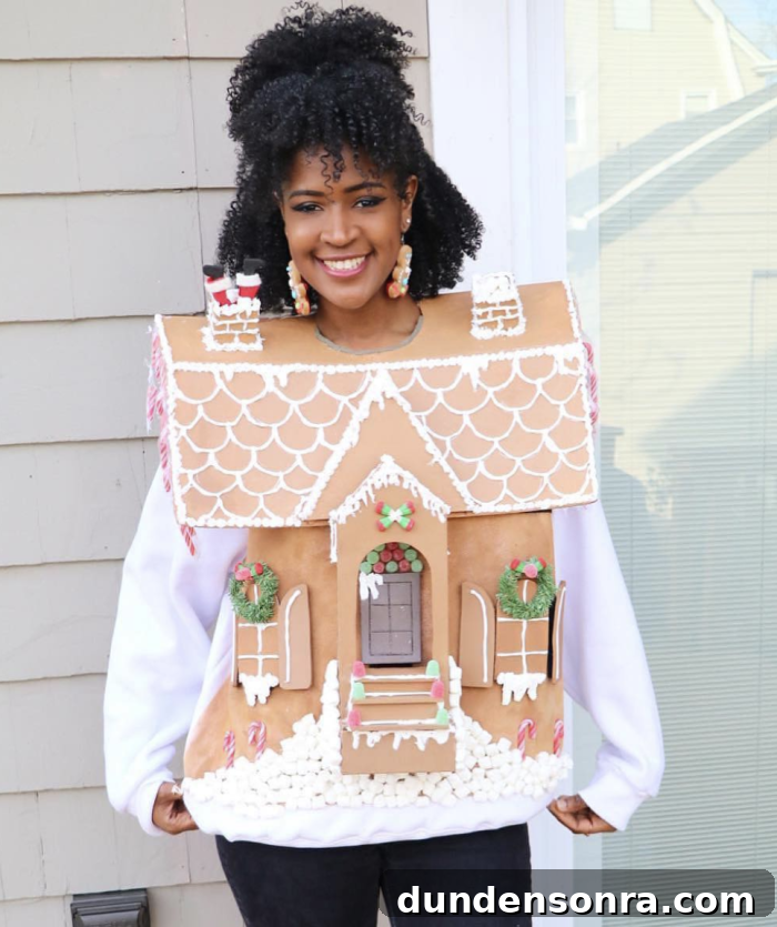 Gingerbread House Costume Woman standing in front of a house while wearing a cardboard gingerbread house.