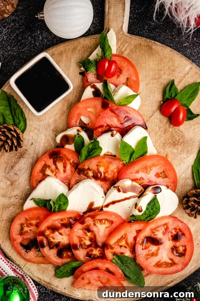 Caprese Christmas Tree Board Tomatoes and mozzarella cheese in the form of a tree on a wooden board.