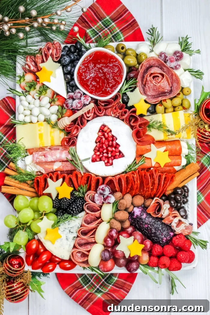Christmas-Themed Charcuterie Board Charcuterie board with cheese stars and brie with a tree cutout.