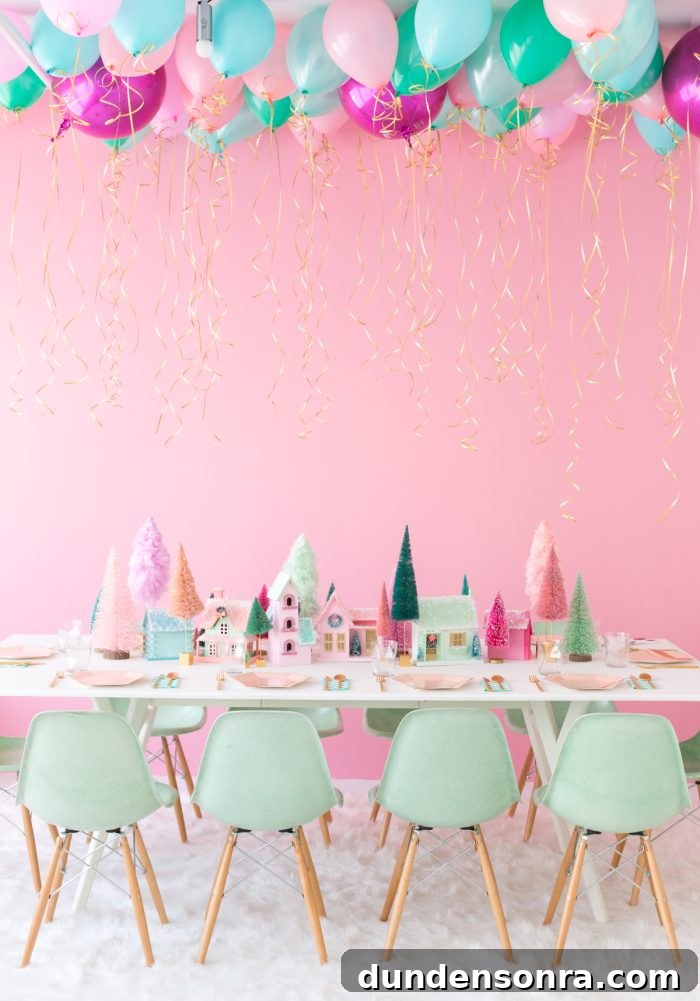 Table set with homemade Christmas village with a pink wall. 