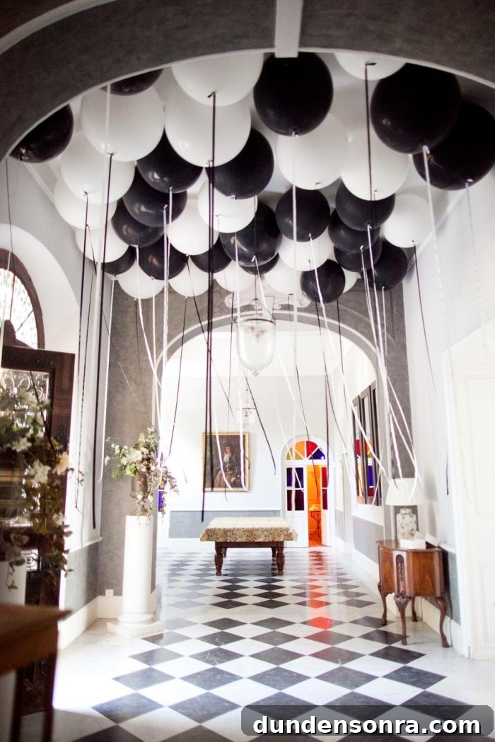Black and white balloons in a room with a black and white floor. 