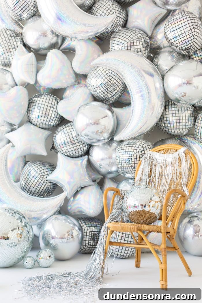 Silver balloons in the shapes of moons, stars, hearts and disco balls. 