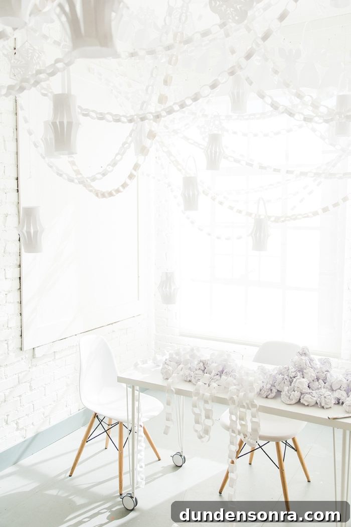 Room decorated with white decorations made out of paper. 