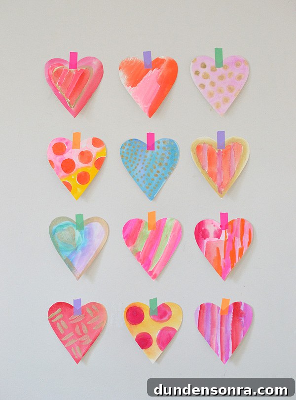 Four rows of colorful watercolor hearts taped to the wall.