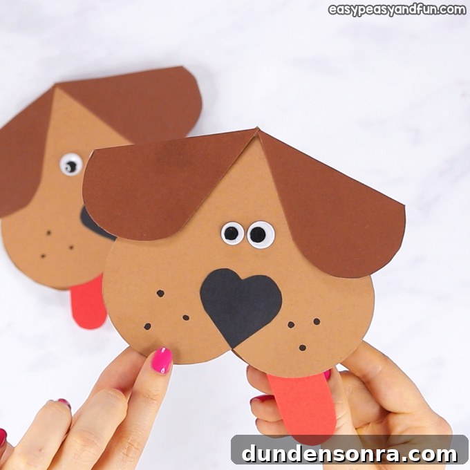 Paper dog that is shaped out of a heart.